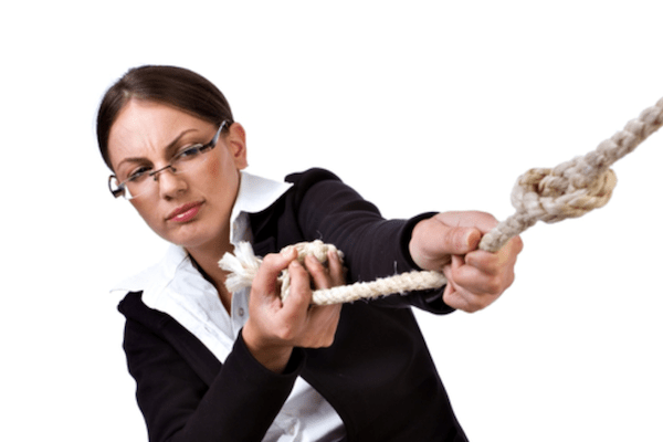 woman pulling hard on a rope